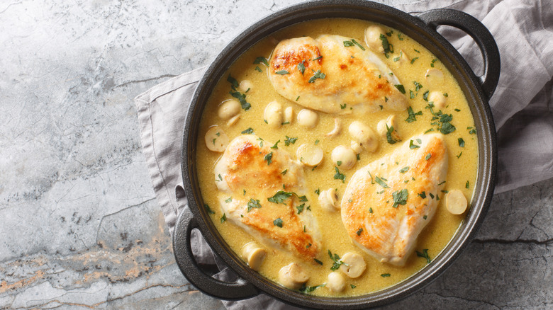 Chicken Dijon with small mushrooms in the sauce.