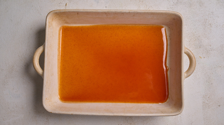 enchilada sauce in a casserole dish