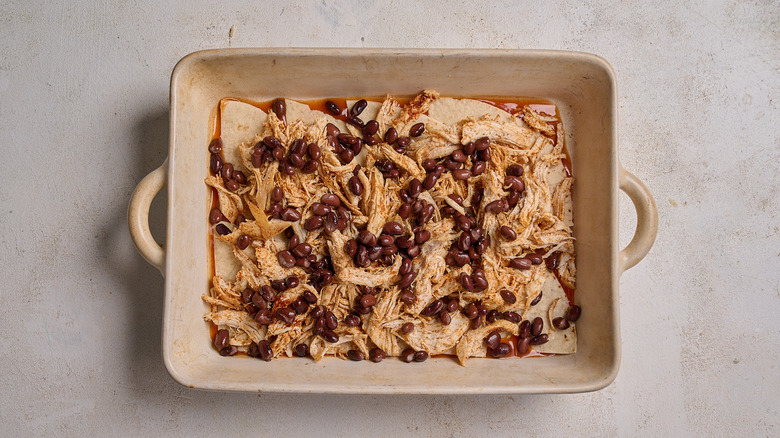 chicken and beans layered into casserole dish