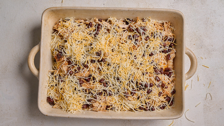 chicken, beans, and cheese layered into casserole