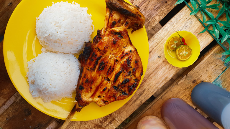 Chicken inasal on a plate with rice