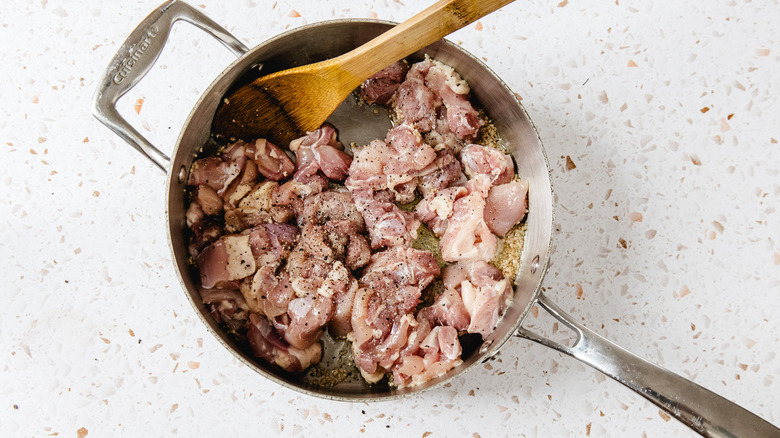 Pan with raw chicken pieces