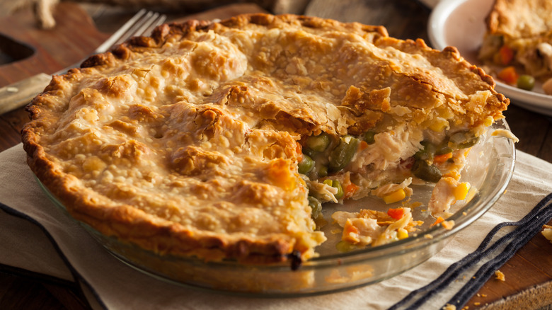 A hearty homemade chicken pot pie with a slice missing
