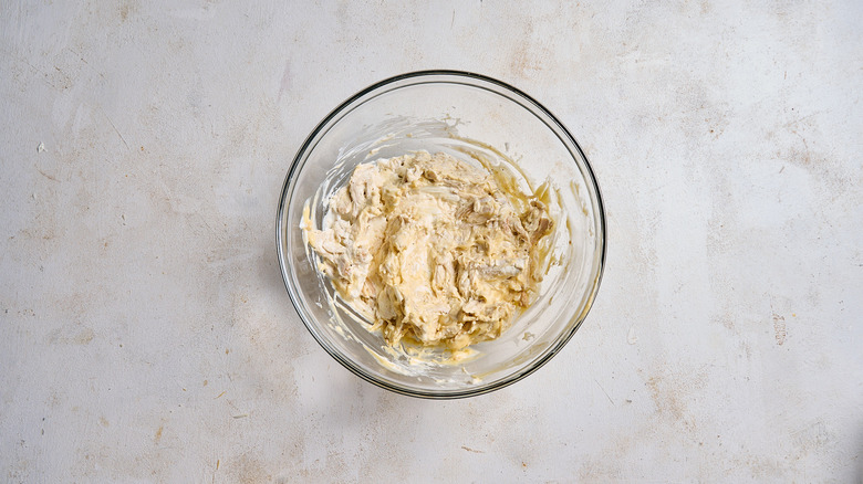 combining casserole ingredients in a bowl
