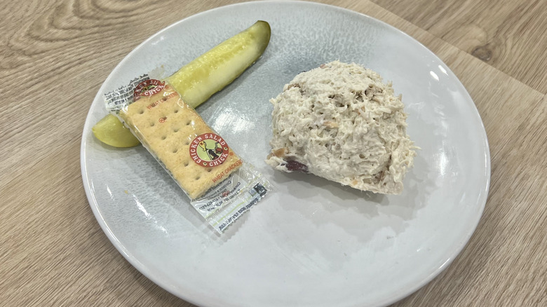 Chicken Salad Chick Cranberry Kelli scoop on a plate with crackers and a pickle