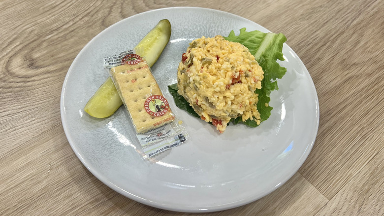 Chicken Salad Chick Jalapeño Pimento Cheese scoop on a plate with crackers and a pickle