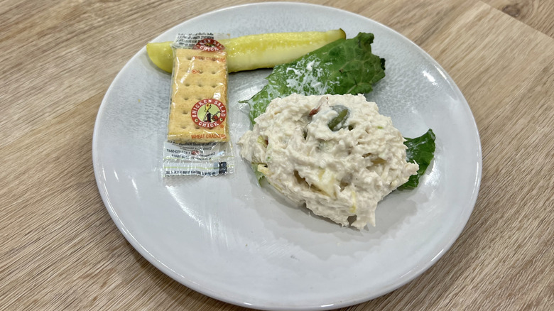 Chicken Salad Chick Fruity Fran scoop on a plate with crackers and a pickle