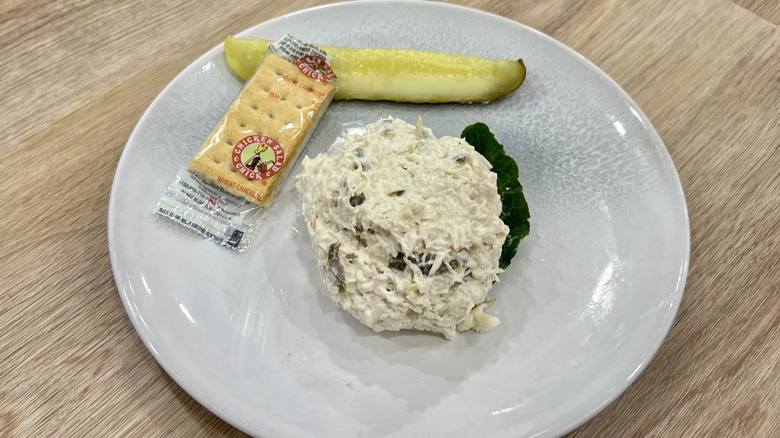 Chicken Salad Chick Jalapeño Holly scoop on a plate with crackers and a pickle