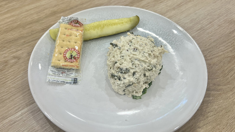 Chicken Salad Chick Lauryn's Lemon Basil scoop on a plate with crackers and a pickle