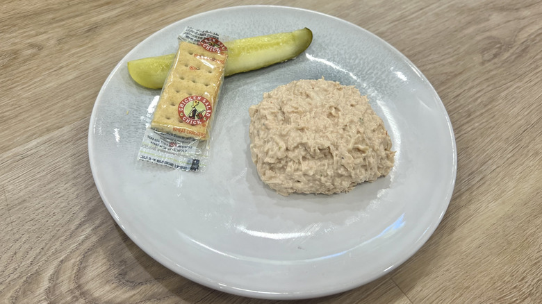 Chicken Salad Chick Barbie-Q scoop on a plate with crackers and a pickle