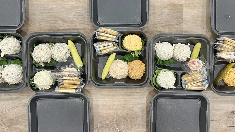 Several different Chicken Salad Chick flavors in to-go boxes