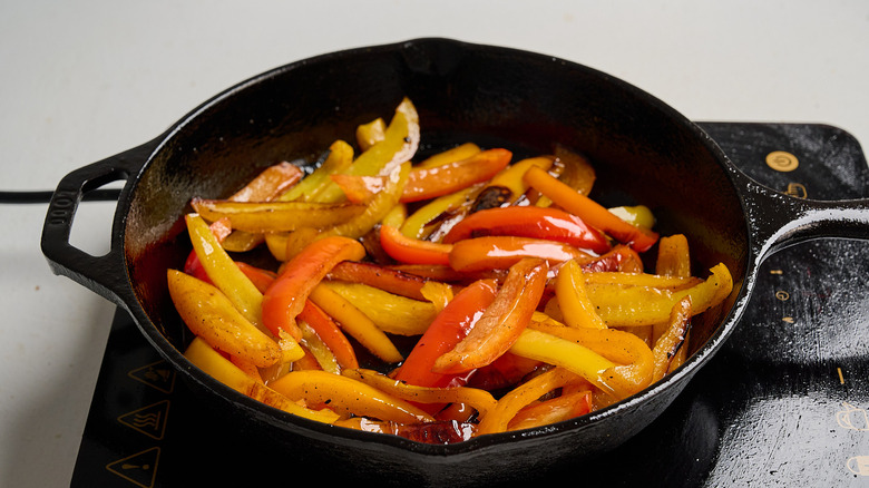 cooking peppers in a skillet