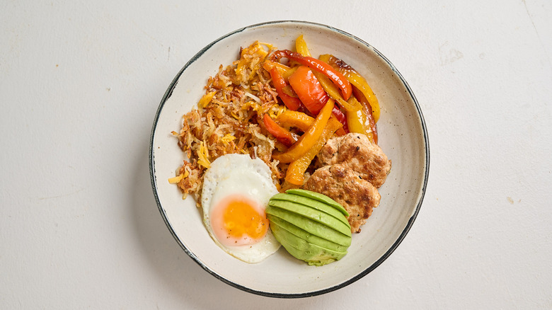 hash brown bowl with egg on a table