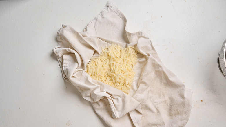 drying potato shreds in a towel