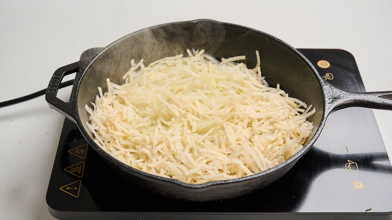 cooking potatoes in a skillet