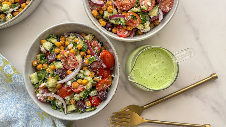 salad in two bowls next to dressing
