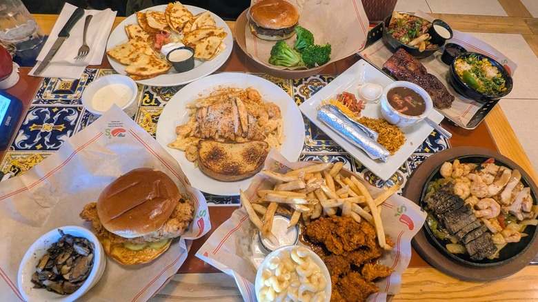 A variety of dishes from Chili's on a colorful restaurant table
