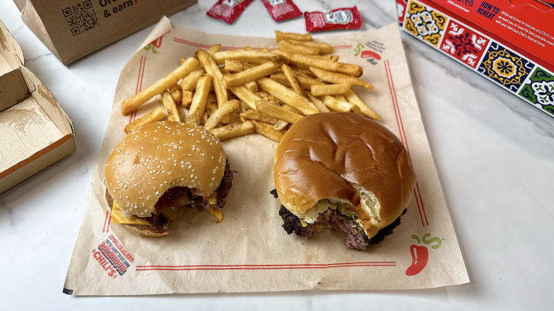 McDonald's Quarter Pounder with Cheese aside the Chili's Big QP burger with a bite out of each burger