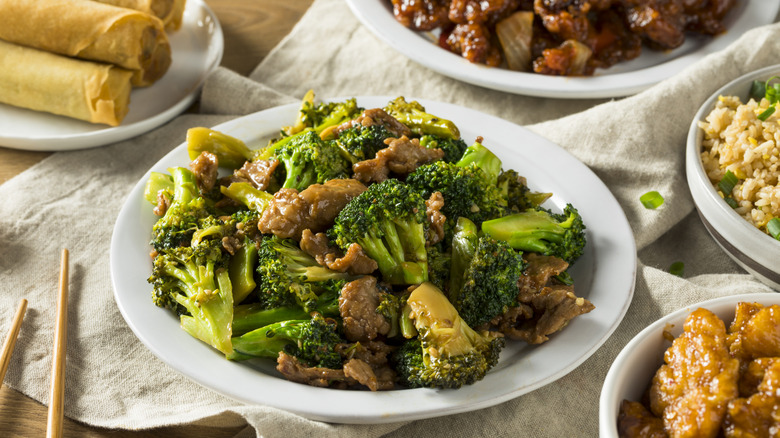 beef and broccoli and other Chinese food on table