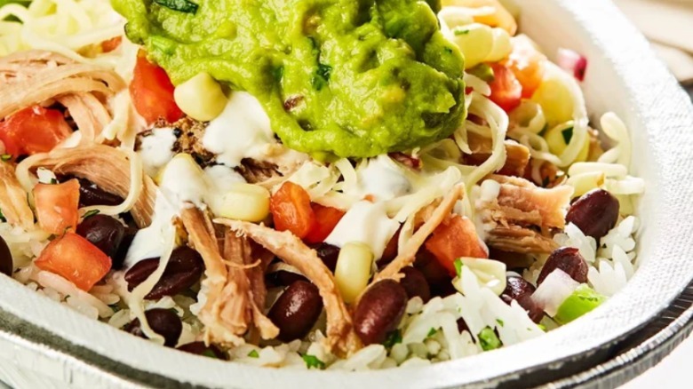A Chipotle carnitas bowl topped with guacomole