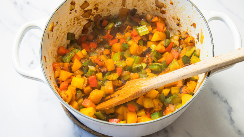 Stirring a large pot of vegetables