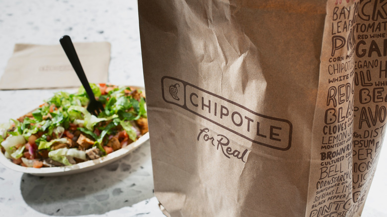 Chipotle burrito bowl and bag on counter