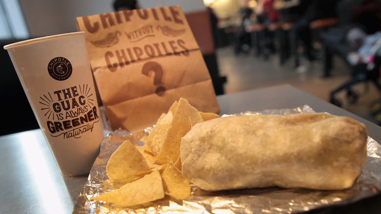 Chipotle burrito with chips, drink, bag