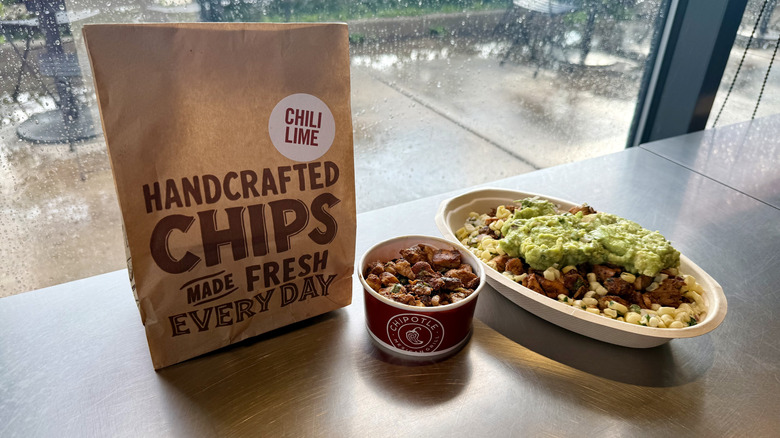 A bag of Chili Lime chips, and Pollo Asada in a cup and bowl