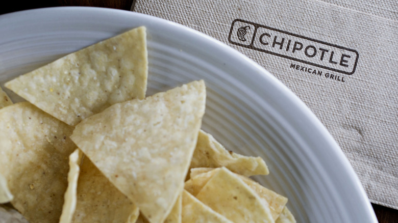 tortilla chips on plate on top of Chipotle napkin