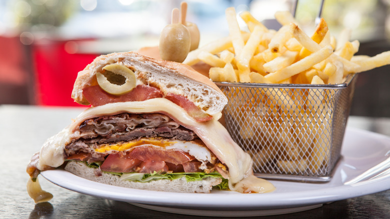 A chivito sandwich with fries