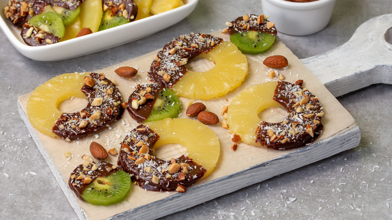 chocolate dipped pineapple and other fruits with coconut and almonds