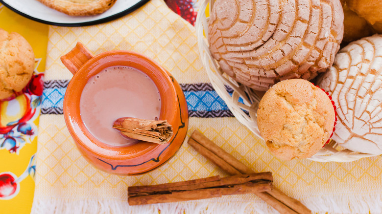 atole de chocolate displayed with pastries