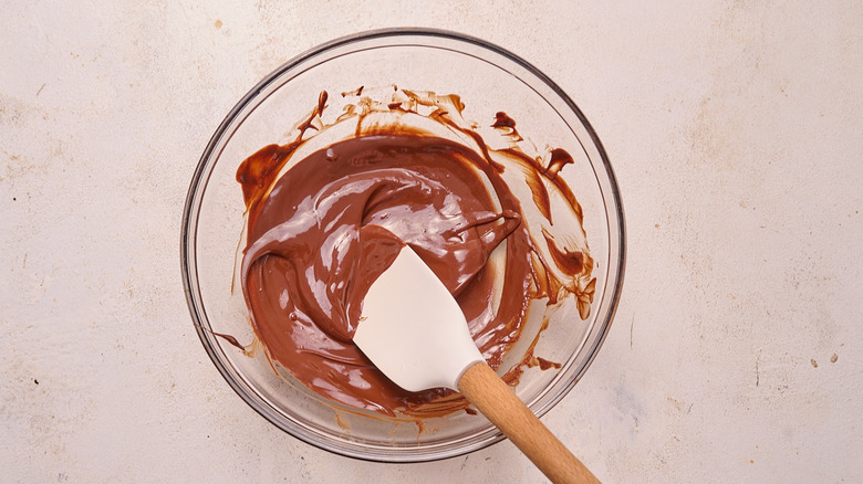 stirring melted chocolate in a bowl