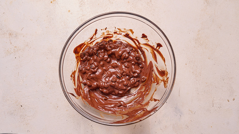 stirring espresso beans into chocolate