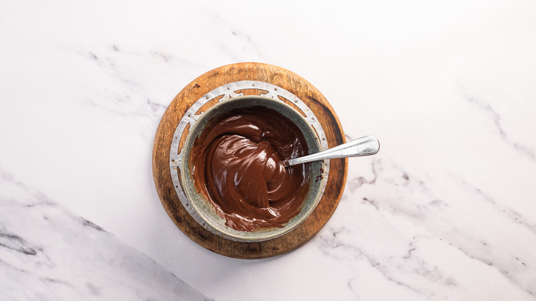 Chocolate ganache in bowl with spoon