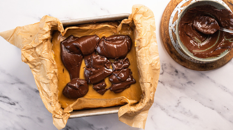 Ganache poured over tray of chocolate lemon bars