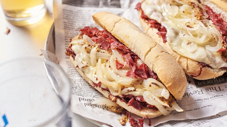 sandwich with pastrami on newspaper