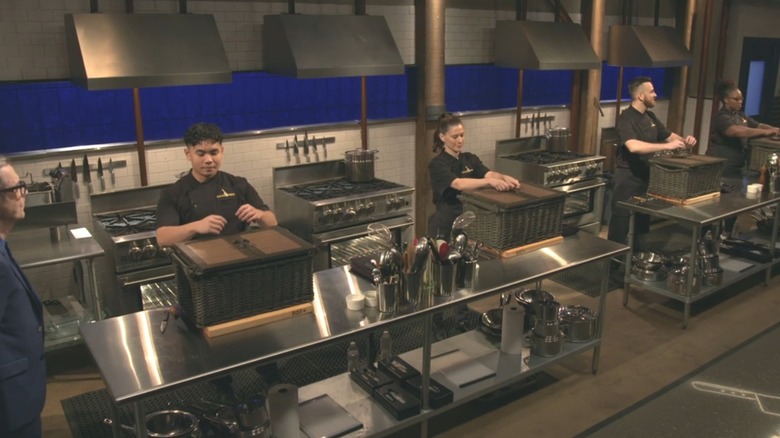 four contestants on Chopped about to open the mystery basket