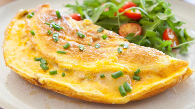 An omelet with green onions and cheese