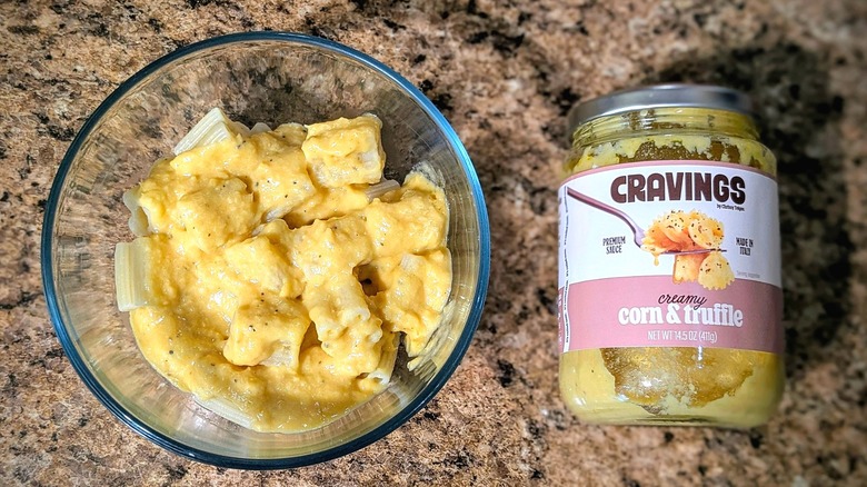 Cravings by Chrissy Teigen Creamy Corn & Truffle pasta sauce on pasta next to jar
