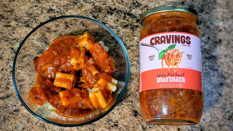 Cravings by Chrissy Teigen Spicy Thai Basil Marinara pasta sauce on pasta next to jar