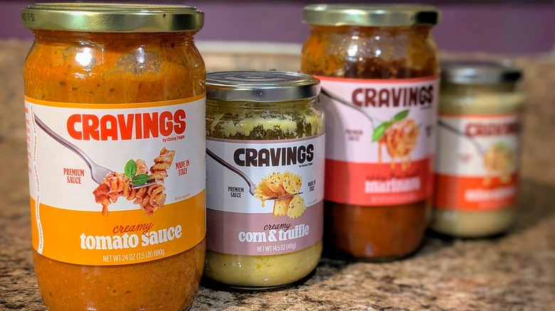 Four Cravings by Chrissy Teigen pasta sauce jars lined up on countertop