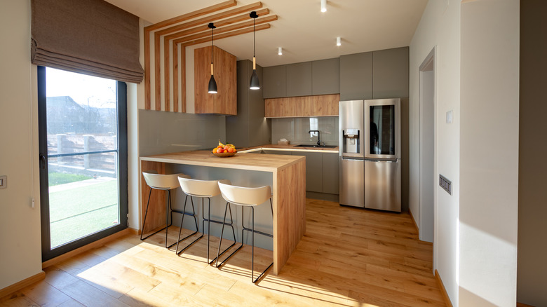 A modern kitchen with a butcher-block kitchen peninsula