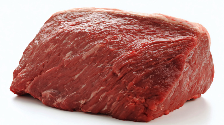 Raw rump roast on white background