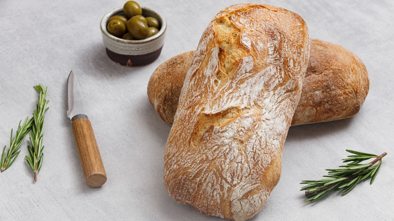 ciabatta with olives, rosemary and a knife