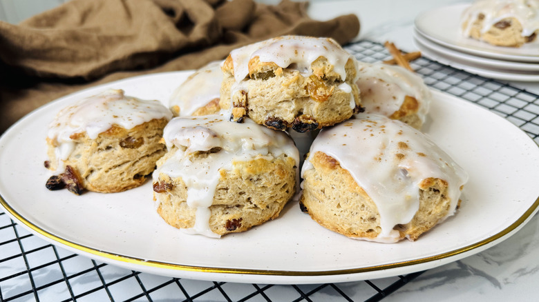 Cinnamon raisin biscuits with glaze on serving platter