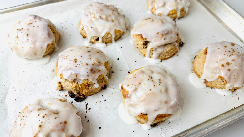 Glazed cinnamon raisin biscuits on baking sheet