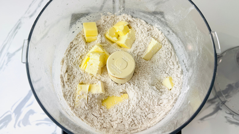 Flour and cubed butter in food processor