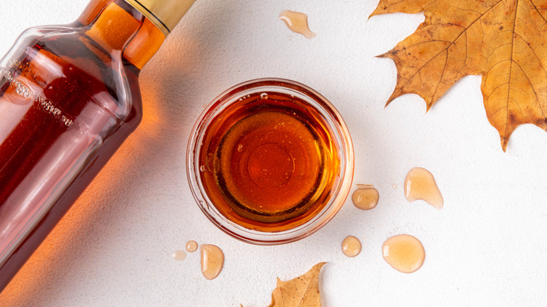 Maple syrup in a bottle with maple leaf