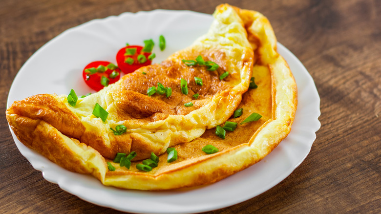 omelet on a plate topped with herbs